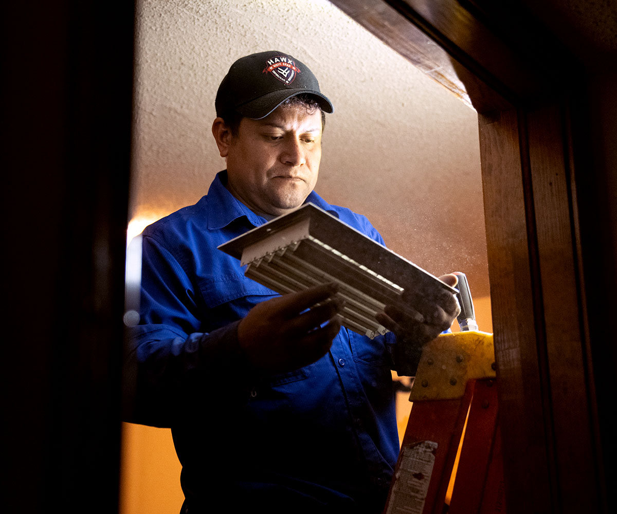 Millennium's technician inspecting vent