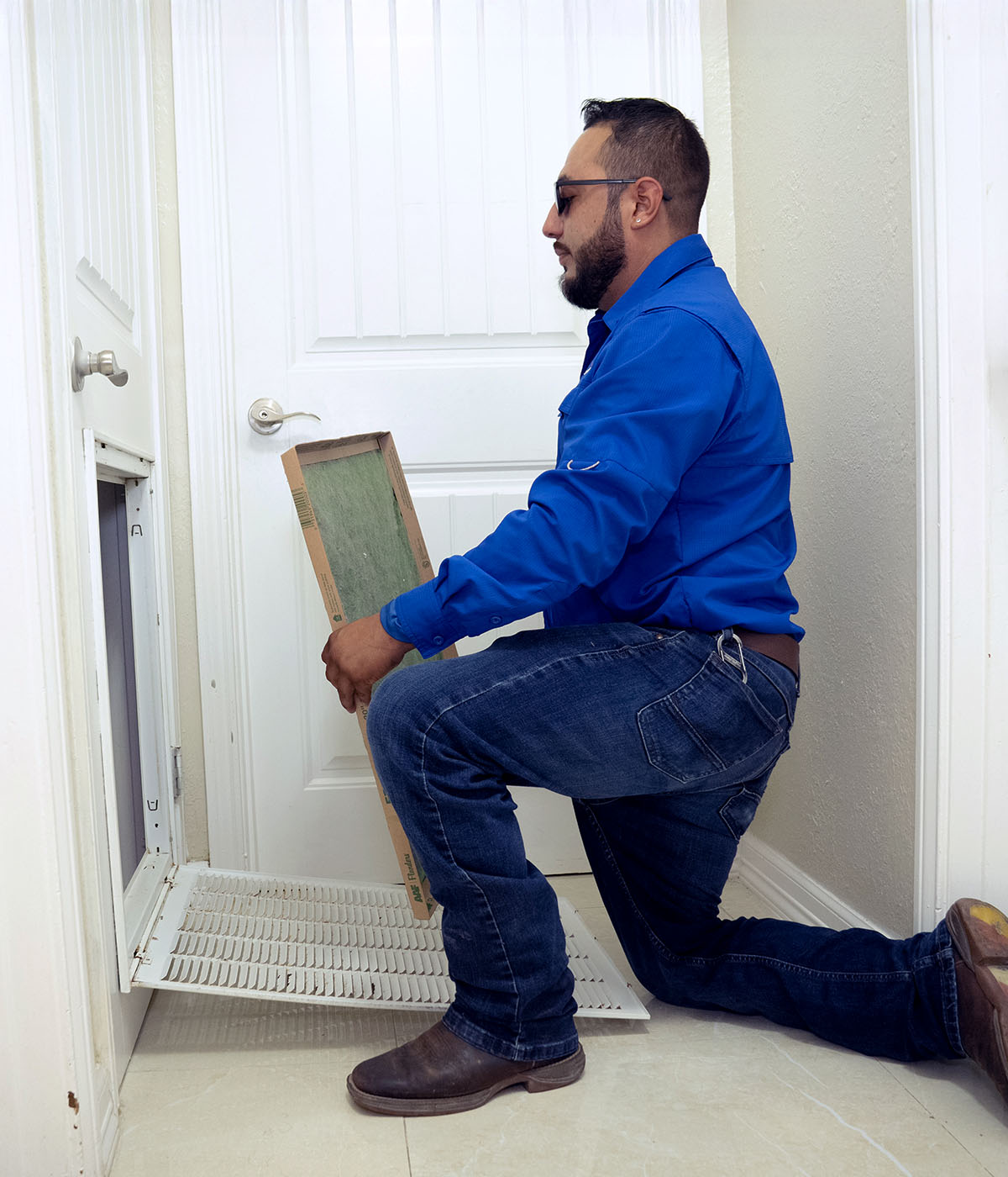 Millennium's technician replacing filter