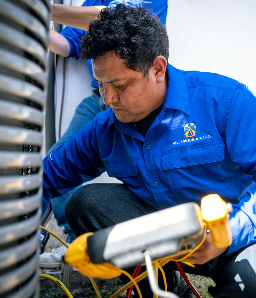 two techs working on HVAC unit outside